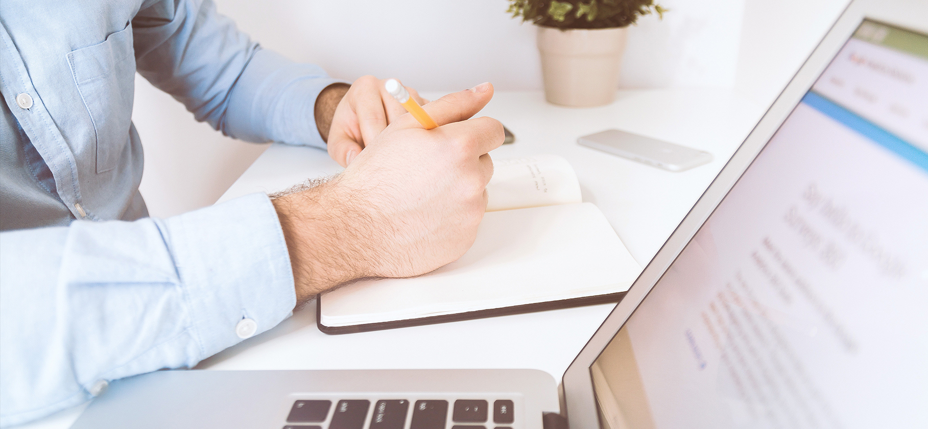 man at a desk with a laptop doing a brand audit