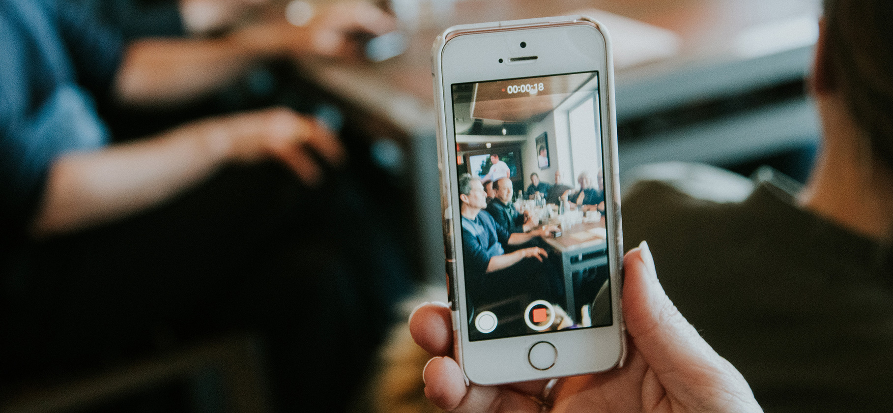 person recording a meeting with phone