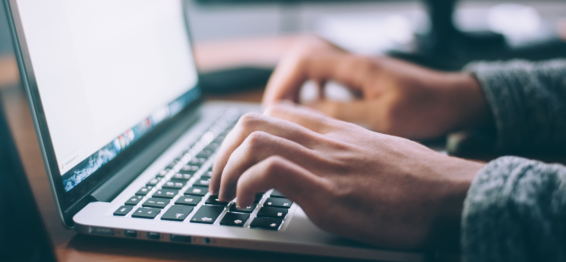 man typing on laptop