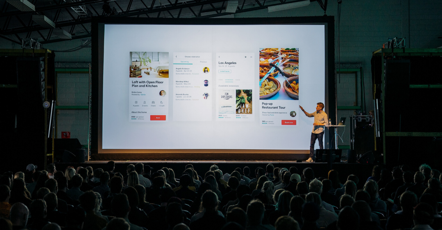 powerpoint presentation in front of large crowd