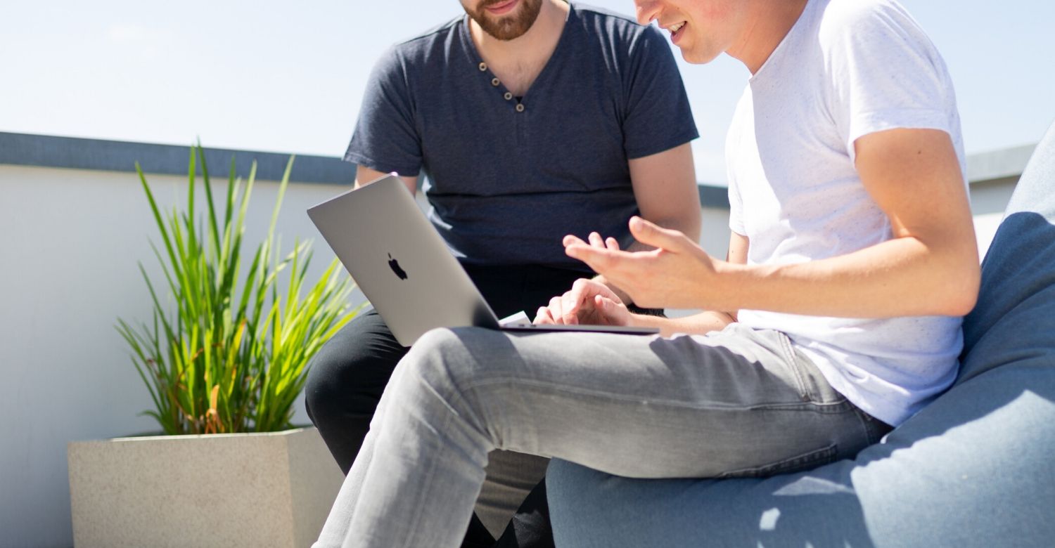 two men at a laptop talking about design