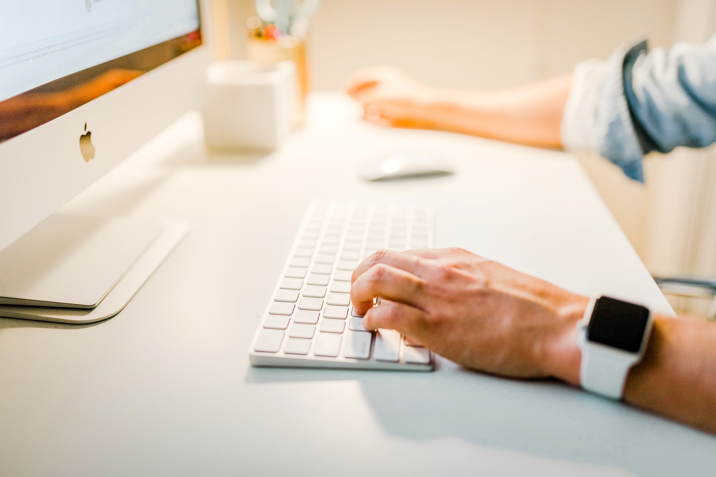 man on computer with close up of hand