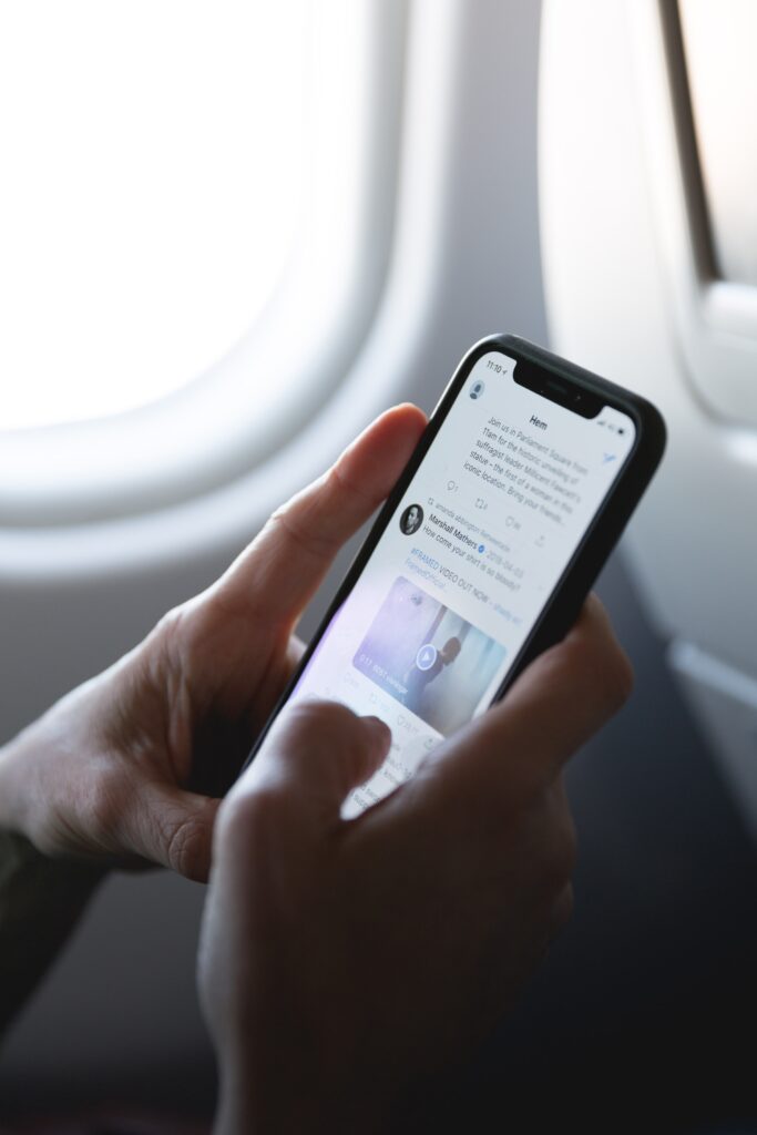 person on plane checking social media